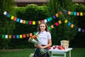 Young teen girl with long hair in school uniform posing with bouquet of flowers Royalty Free Stock Photo