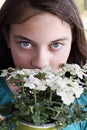 Beautiful Young Teen Girl Smelling Verbena Flowers