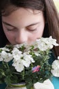 Young Teen Girl Smelling Verbena Flowers