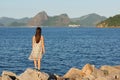 Young teen girl standing on stones in dress with long brown hair Royalty Free Stock Photo