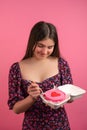 Young teen girl tasting bento cake with heart on top