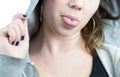 Young teen girl with tongue piercing and hoodie Royalty Free Stock Photo