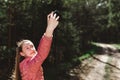 Young teen girl traveler taking selfie on mobile phone in a summer day forest. girl looking at smartphone camera Royalty Free Stock Photo