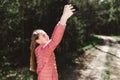 Young teen girl traveler taking selfie on mobile phone in a summer day forest. girl looking at smartphone camera Royalty Free Stock Photo