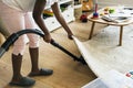 Young teen girl vacuuming up the house