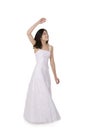 Young teen girl in white dress twirling
