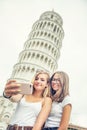 Young teen girls traveler tourist before Pisa tower selfie for smartphone picture or video Royalty Free Stock Photo