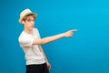 Young teen man points palms aside isolated on blue. Friendly well-looking boy paying your attention at copy space, best deal, sale Royalty Free Stock Photo