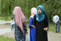 Young teen Muslim girl in hijab holding in hands two mobile phones shouting angry. Celebration of Hidirelez. Kyiv Royalty Free Stock Photo