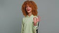 Young teen school girl in glasses looking approvingly at camera showing okey gesture, like sign Royalty Free Stock Photo