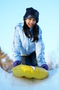 Young teen sledding down hill Royalty Free Stock Photo