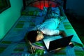 Young Teen sleeping front of a laptop computer and on a bed Royalty Free Stock Photo