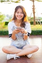 young teen woman and smartphone in hand smiling with happy emotion