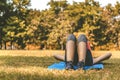 Young teen women in sport suit lay down to sleep and relaxing on the green grass in the park after running exercise in summer Royalty Free Stock Photo