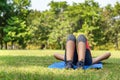 Young teen women in sport suit lay down to sleep and relaxing on the green grass in the park after running exercise in summer Royalty Free Stock Photo