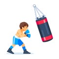 A young teenage boxer trains with a sandbag for boxing. Fitness, sports, exercise, willpower and lifestyle concept