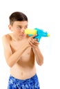 Young teenage boy playing with water guns