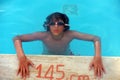 Young teenage boy on poolside