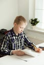 Young Teenage Boy Sitting at Desk Doing Homework Royalty Free Stock Photo