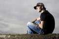 Young teenage boy sitting thinking