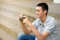 Young teenage boy smiling as he checks his camera Royalty Free Stock Photo