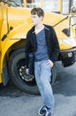 Young teenage boy waiting for bus to go home. Royalty Free Stock Photo