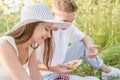 Young couple having picnic on sunflower field Royalty Free Stock Photo