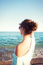 Young beautiful teenage girl looking forward at Mediterranean Sea beach Royalty Free Stock Photo