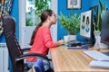Young teenage female using graphics tablet to draw on computer Royalty Free Stock Photo