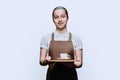 Young teenage female waitress holding tray with cup of coffee, on white background Royalty Free Stock Photo