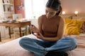 Teenage girl applicating insulin with insulin pen.