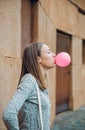 Young teenage girl blowing pink bubble gum Royalty Free Stock Photo