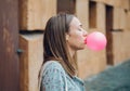 Young teenage girl blowing pink bubble gum Royalty Free Stock Photo