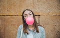 Young teenage girl blowing pink bubble gum Royalty Free Stock Photo