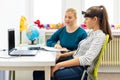 Young teenage girl and child therapist during EEG neurofeedback session. Electroencephalography concept. Royalty Free Stock Photo