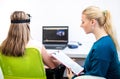 Young teenage girl and child therapist during EEG neurofeedback session. Electroencephalography concept. Royalty Free Stock Photo