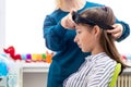 Young teenage girl and child therapist during EEG neurofeedback session. Electroencephalography concept. Royalty Free Stock Photo