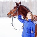 Young teenage girl with her horse in winter park Royalty Free Stock Photo