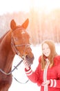 Young teenage girl with her horse in winter park Royalty Free Stock Photo