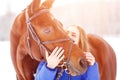 Young teenage girl with her horse in winter park Royalty Free Stock Photo