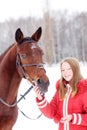 Young teenage girl with her horse in winter park Royalty Free Stock Photo