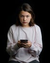 Young teenage girl holding cell phone