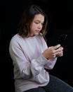 Young teenage girl holding cell phone