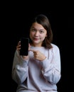 Young teenage girl holding cell phone