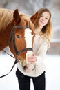 Young teenage girl with horse in winter park Royalty Free Stock Photo