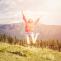 Young teenage girl jumping in mountains Royalty Free Stock Photo