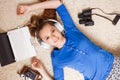 Young teenage girl lying on the floor with laptop Royalty Free Stock Photo