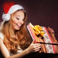 A young teenage girl opening the present Royalty Free Stock Photo