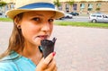 Young teenage girl outdoors eating black ice cream cone on the city Royalty Free Stock Photo