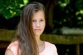 Young teenage girl in the park with calm facial expression. Royalty Free Stock Photo